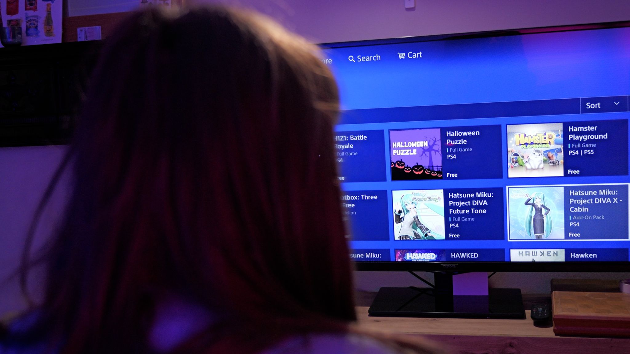 Image:
        Person picks a game on the PlayStation Store