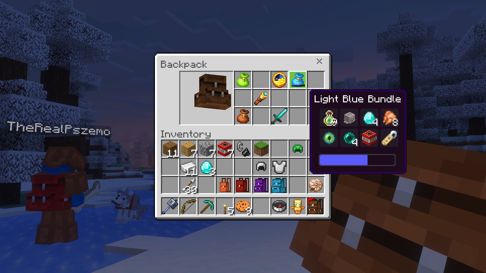 Minecraft backpack inventory menu displays stored items and a Light Blue Bundle, with a snowy forest visible behind.